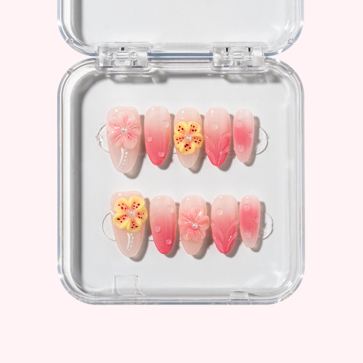 Peach Fizz nail set with peach gradient, 3D floral petals, and dewdrop accents, inspired by summer peach soda.